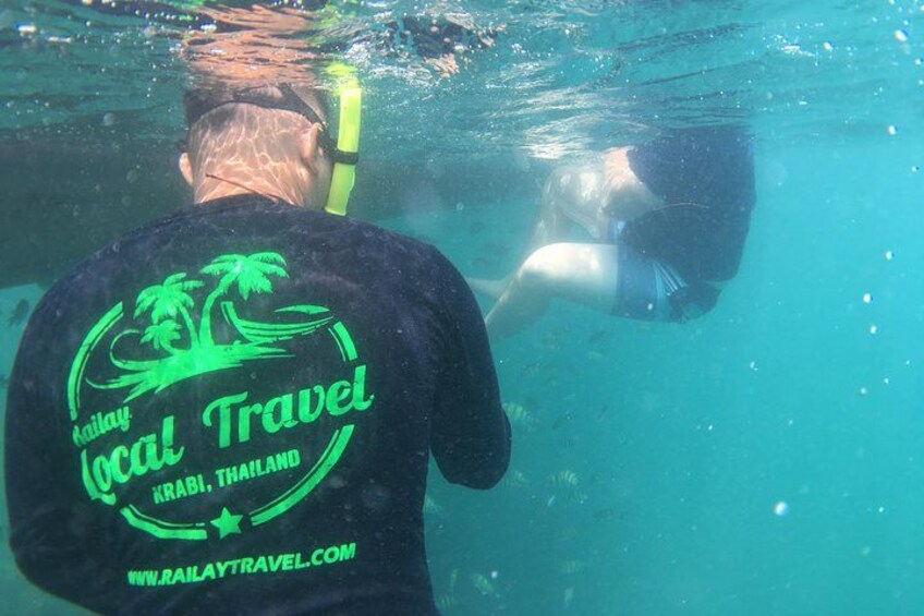 A person snorkeling underwater with a snorkel and mask. 3