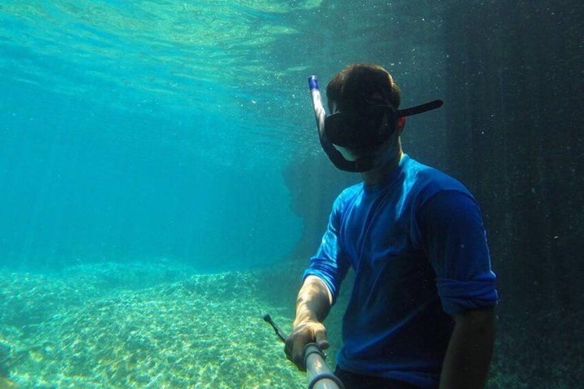 A person snorkeling underwater. 4