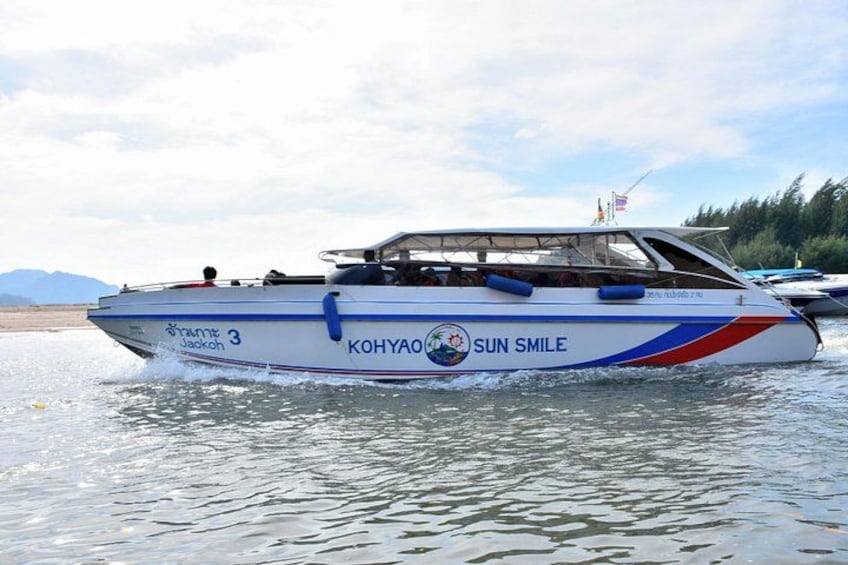 A boat named 'Kohyao Sun Smile' with the number 3 on its side, moving on water. 1