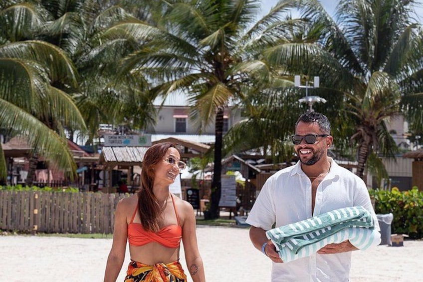 A beach with palm trees and a wooden fence. 4