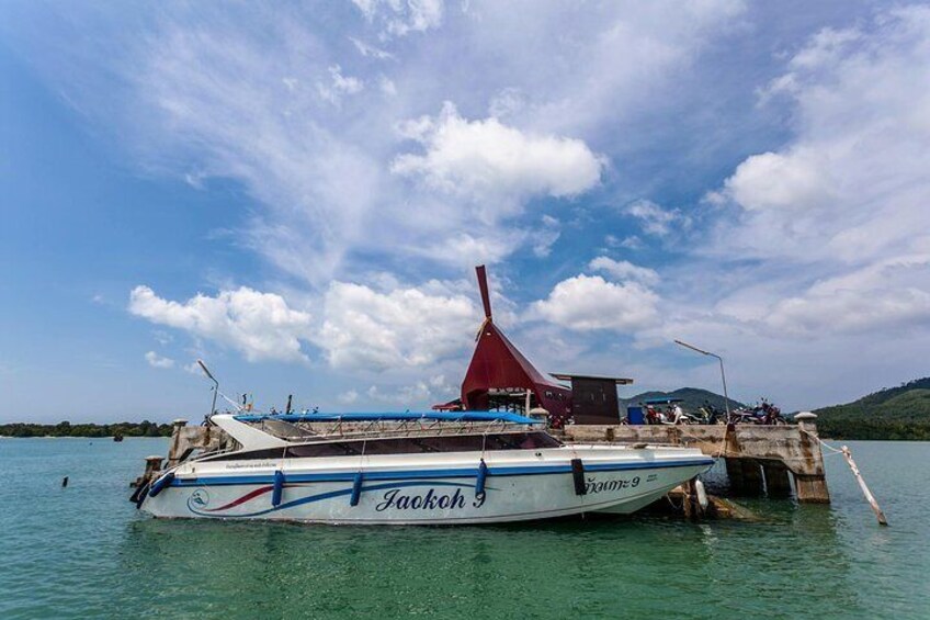 A boat named 'Jackoch 9' docked at a pier with a red structure in the background. 4