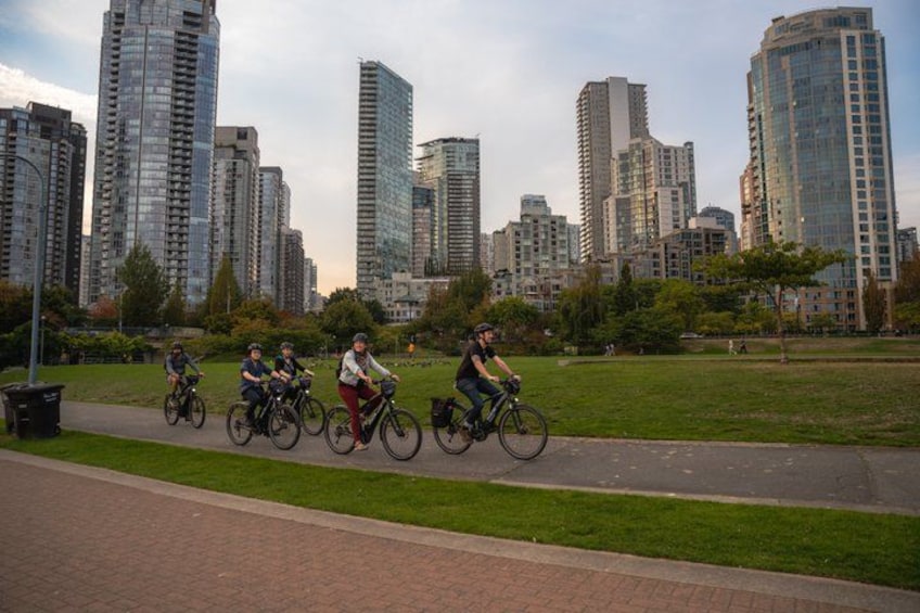 Cyclists on a path with a cityscape in the background. 3