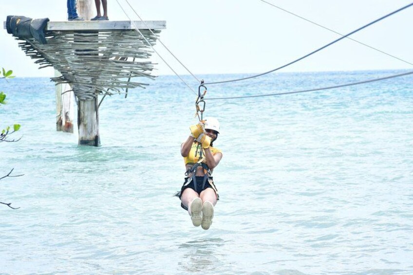 A person bungee jumping from a high platform over water. 3