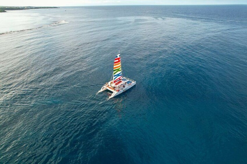 A sailboat with a colorful sail on the ocean. 2