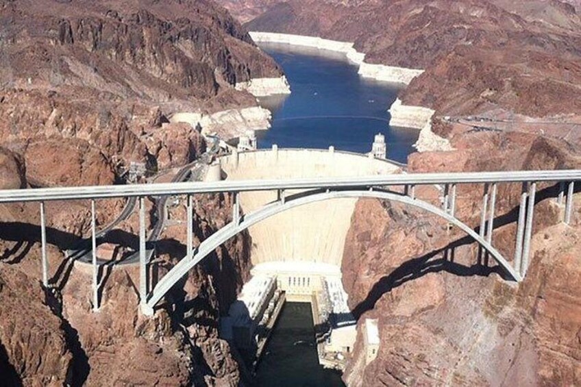 A dam with a bridge crossing over a canyon. 4