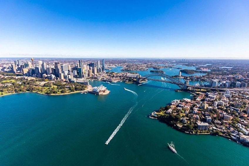 A city skyline, a bridge, and a body of water. 1