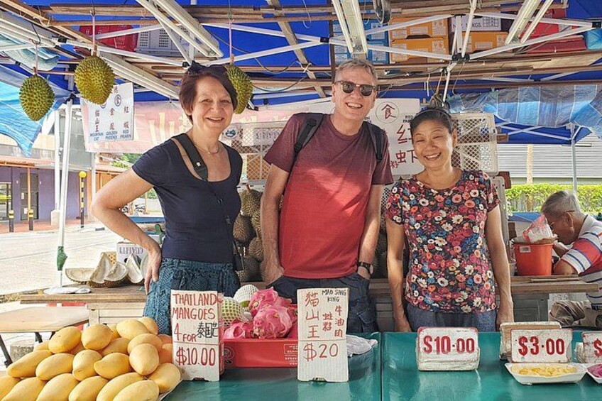 A street vendor stall with durians and mangos for sale. 3