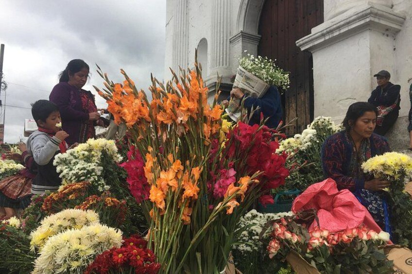 A market with various flowers and people. 5