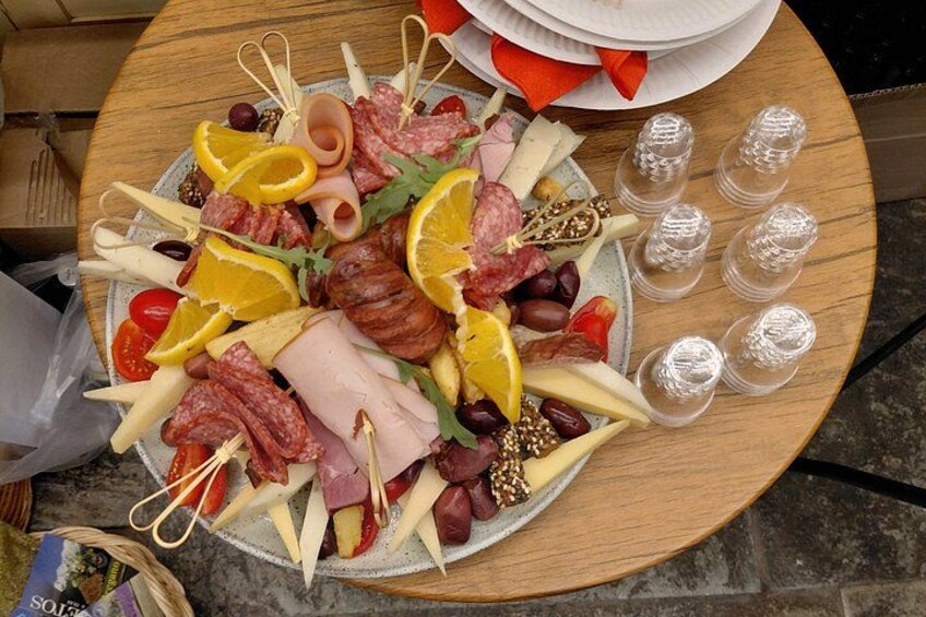 A charcuterie board with various meats, cheeses, and fruits. 3