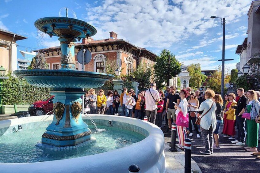 A fountain with a crowd of people around it. 4