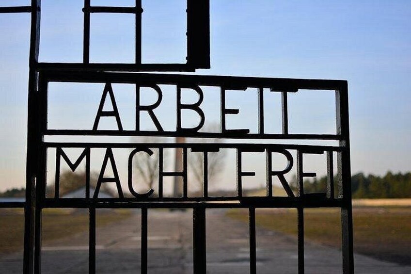A metal gate with the words 'ARBEIT MACHTERFREI' engraved on it. 1