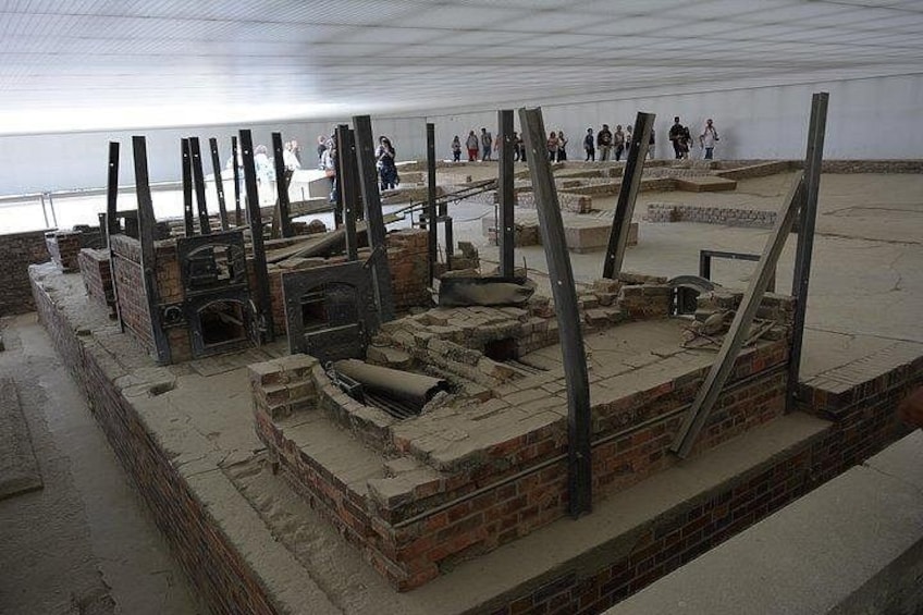An archaeological site with brick structures and metal beams. 3