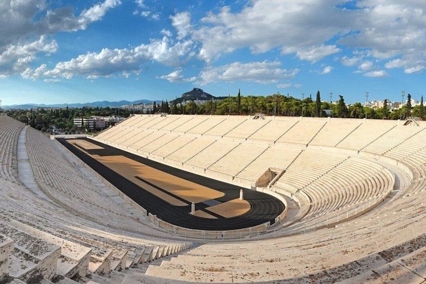 An empty amphitheater with tiered seating and a central stage. 3