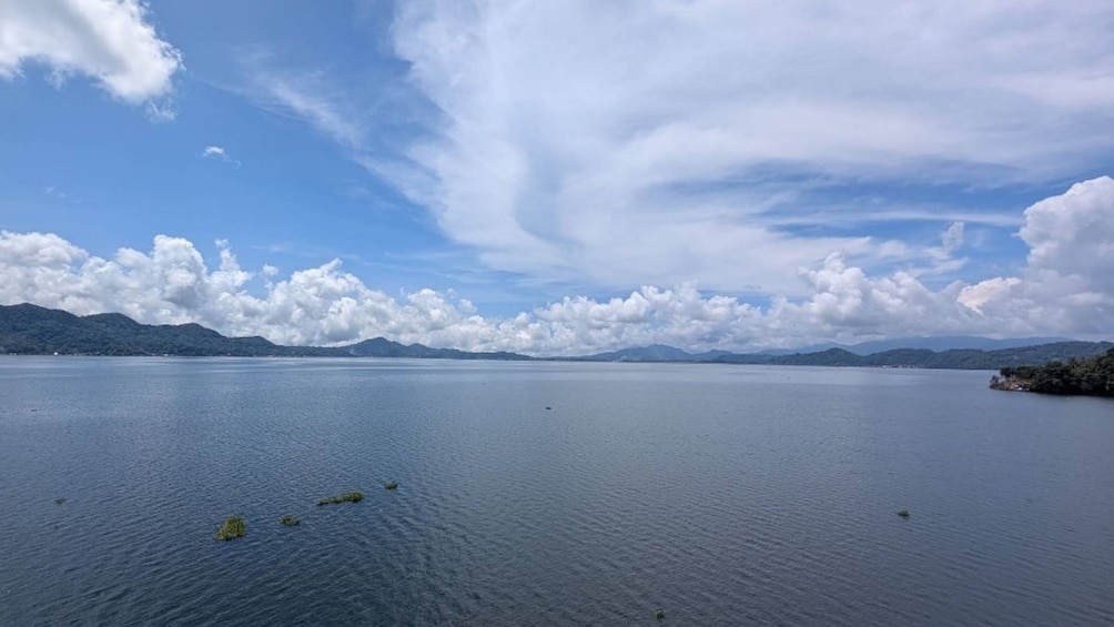 A calm lake with a clear sky and distant mountains. 3