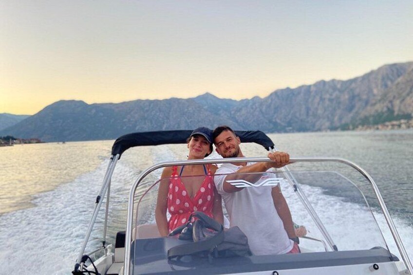 A boat on a lake with mountains in the background. 2