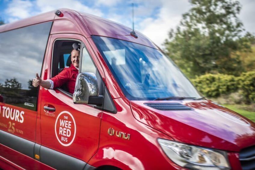 A red van with 'The Wee Red Bus' and 'TOURS' branding, parked outdoors. 2