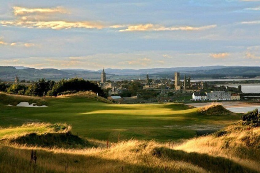 A golf course with a historic castle in the background. 3