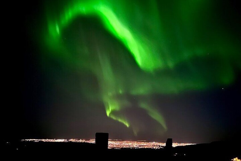 The Northern Lights over a city skyline. 5