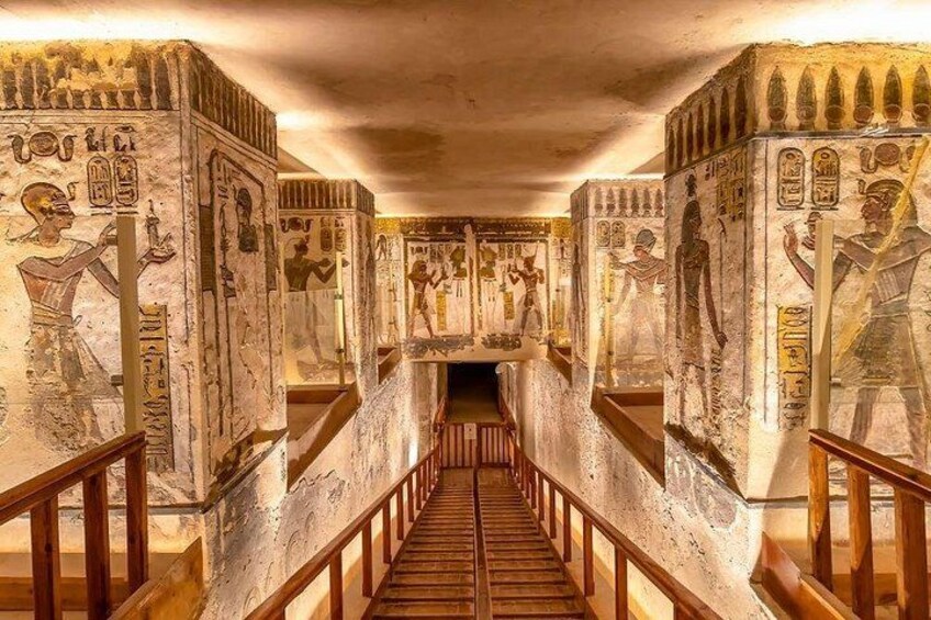 A corridor with hieroglyphs and statues, leading to a central chamber. 4