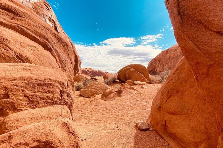 A desert landscape with large red rock formations and a clear blue sky. 2