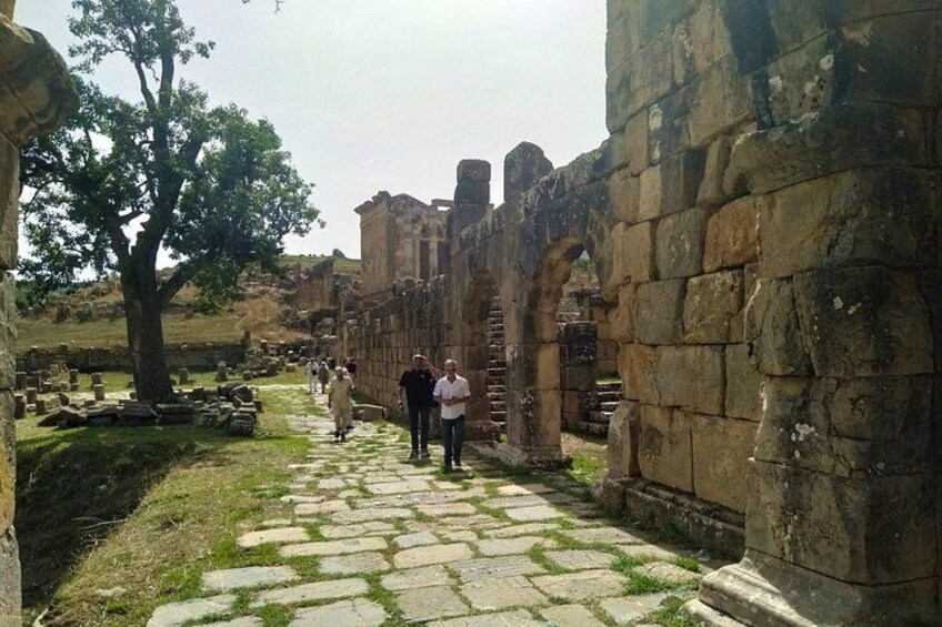 Ancient stone ruins with columns and a cobblestone path. 4