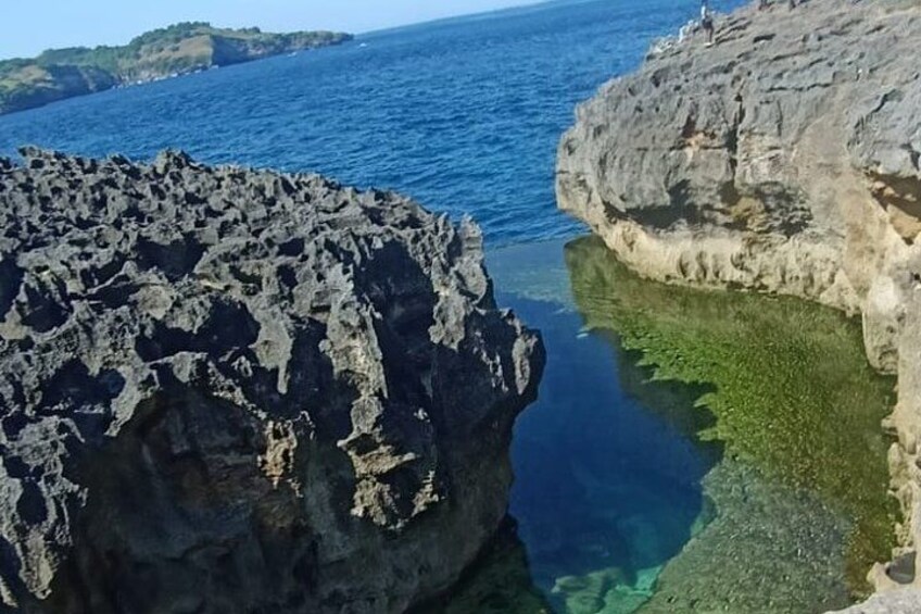 A rocky coastline with clear blue water. 2