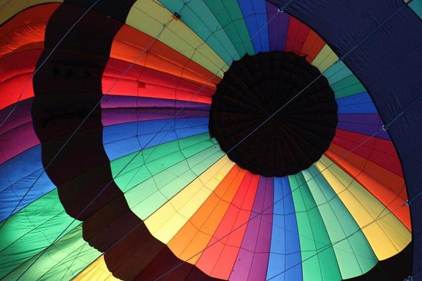 A colorful hot air balloon with a rainbow pattern. 4