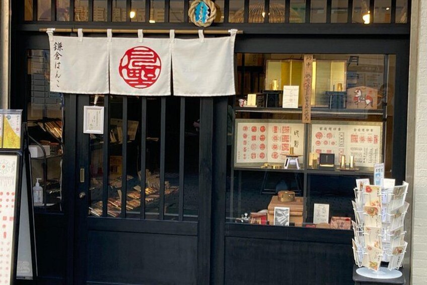 A storefront with a black door, a display of books, and a menu board. 3