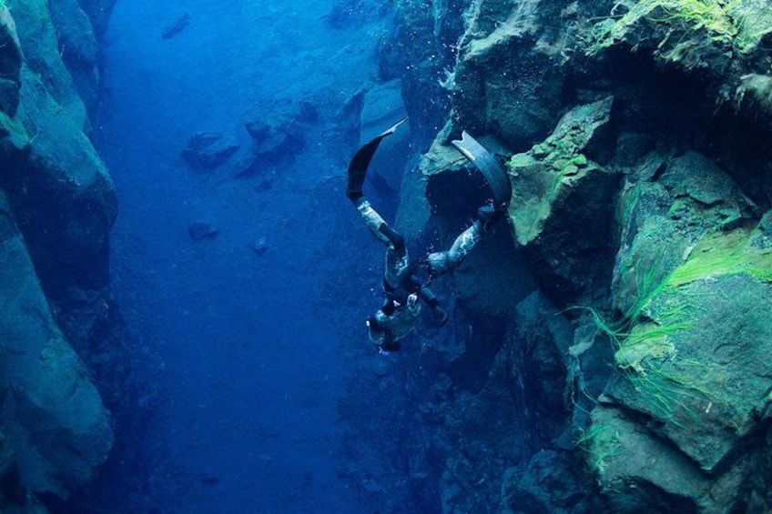 A diver exploring underwater rock formations. 4