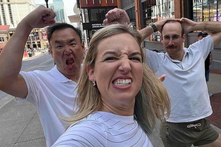 Three people taking a selfie on a city street. 2