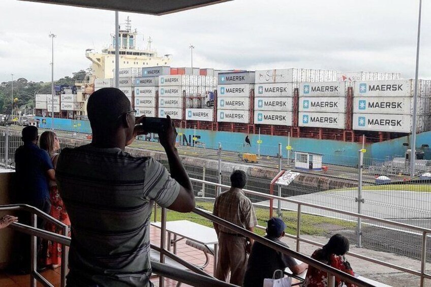 Un hombre fotografiando un barco grande con múltiples contenedores de 'MAERSK'. 4