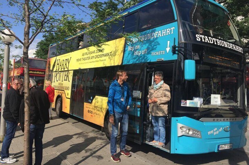 A double-decker bus with a Harry Potter advertisement, parked on a city street. 5