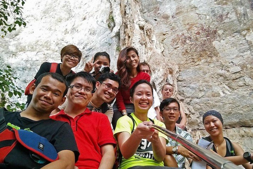 A group of people in a rocky outdoor setting, possibly a hiking trail. 4