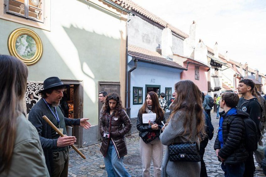 A cobblestone street with people walking and interacting. 3