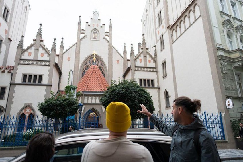 A historic building with a red-tiled roof and ornate architecture. 2