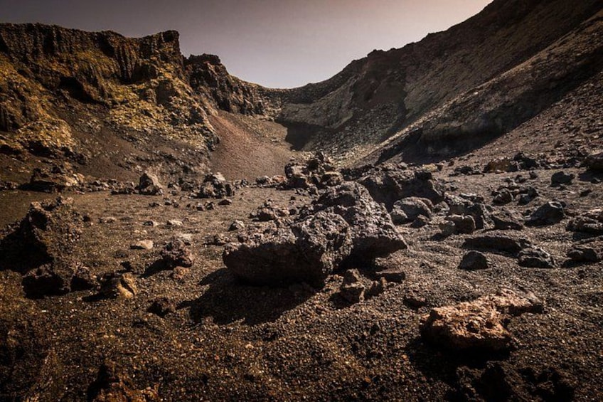 A rugged mountainous landscape with rocky terrain and sparse vegetation. 1