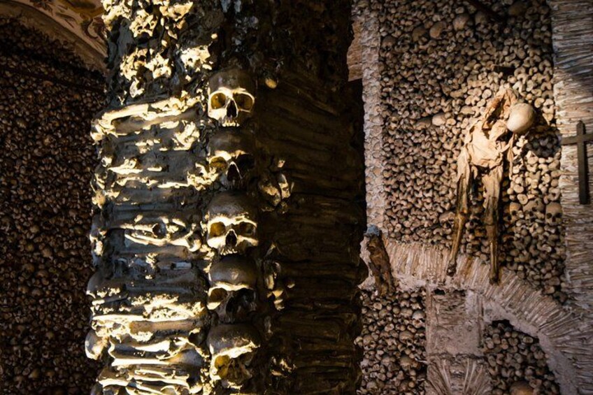 A cave with a skeleton and skulls. 2