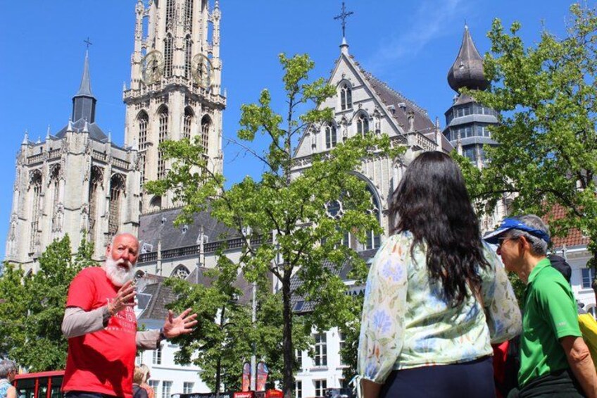 En historisk katedral med detaljeret arkitektur, en person der gestikulerer, og en kvinde i en blomstret bluse. 5