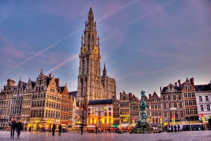A historic square with a prominent cathedral, a statue, and traditional European architecture. 3