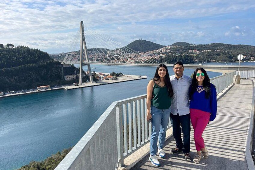 A bridge, a body of water, and a hilly landscape. 4
