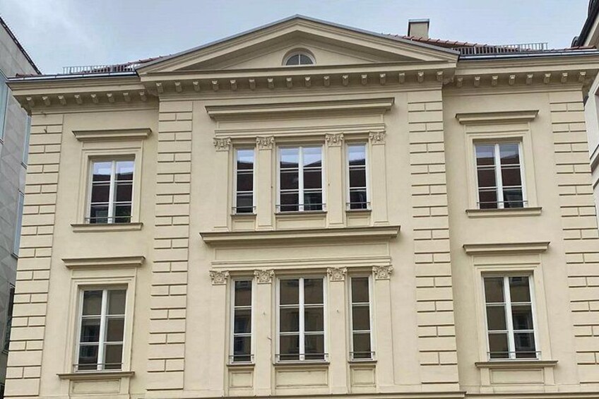 A classical building with symmetrical windows and a central pediment. 5