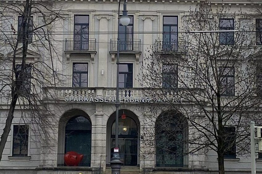 A building with arched windows and a sign that reads 'SPARKASSEN ERBANZ.' 3
