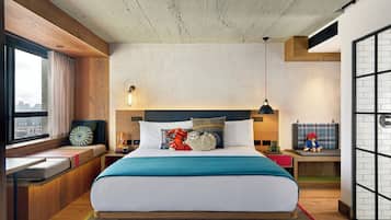 Relax in a serene space with a large bed, desk, and cozy seating area.