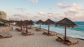 On the beach, sun-loungers, beach umbrellas, beach massages