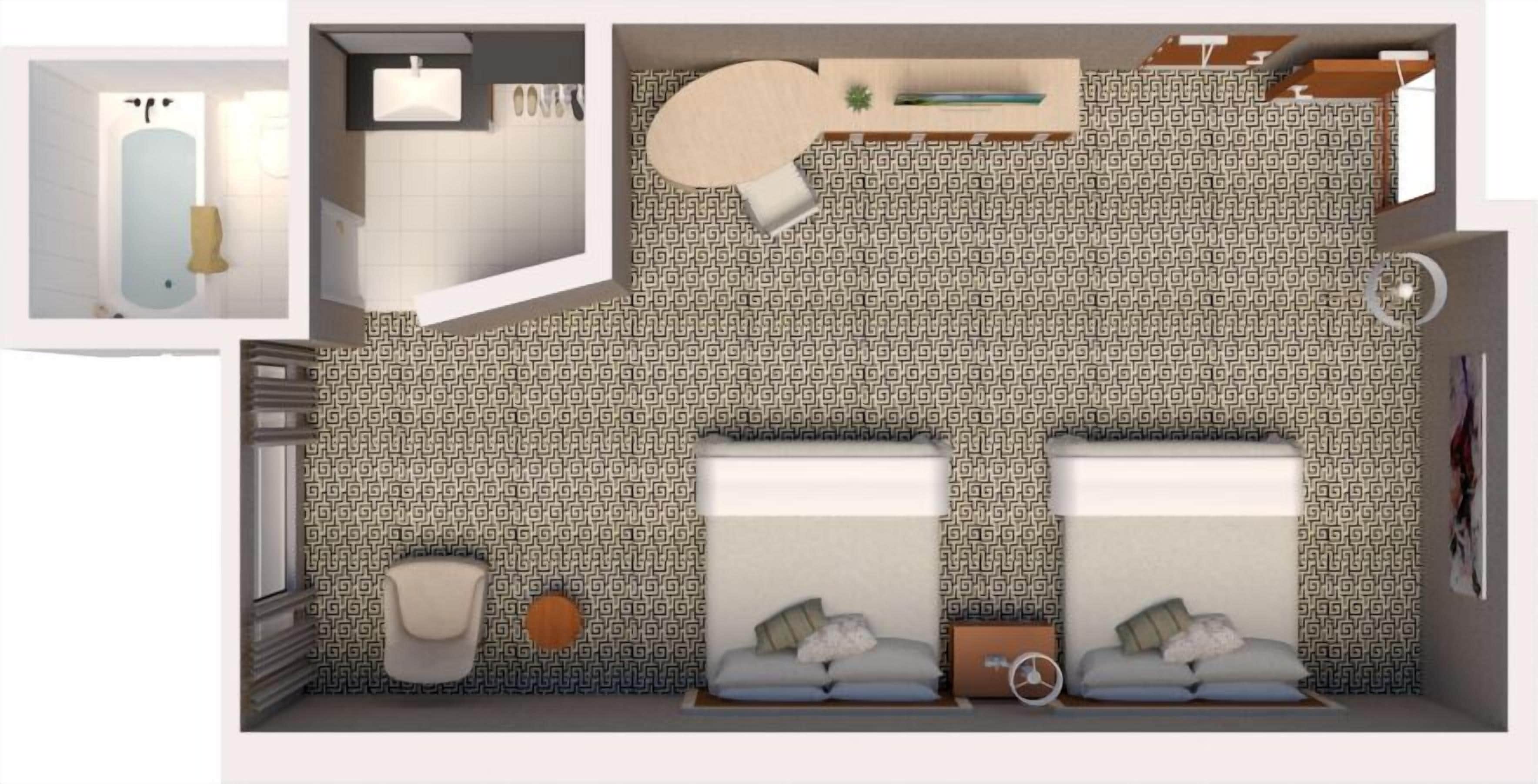A room with two beds, a small bathroom, and a patterned wall.