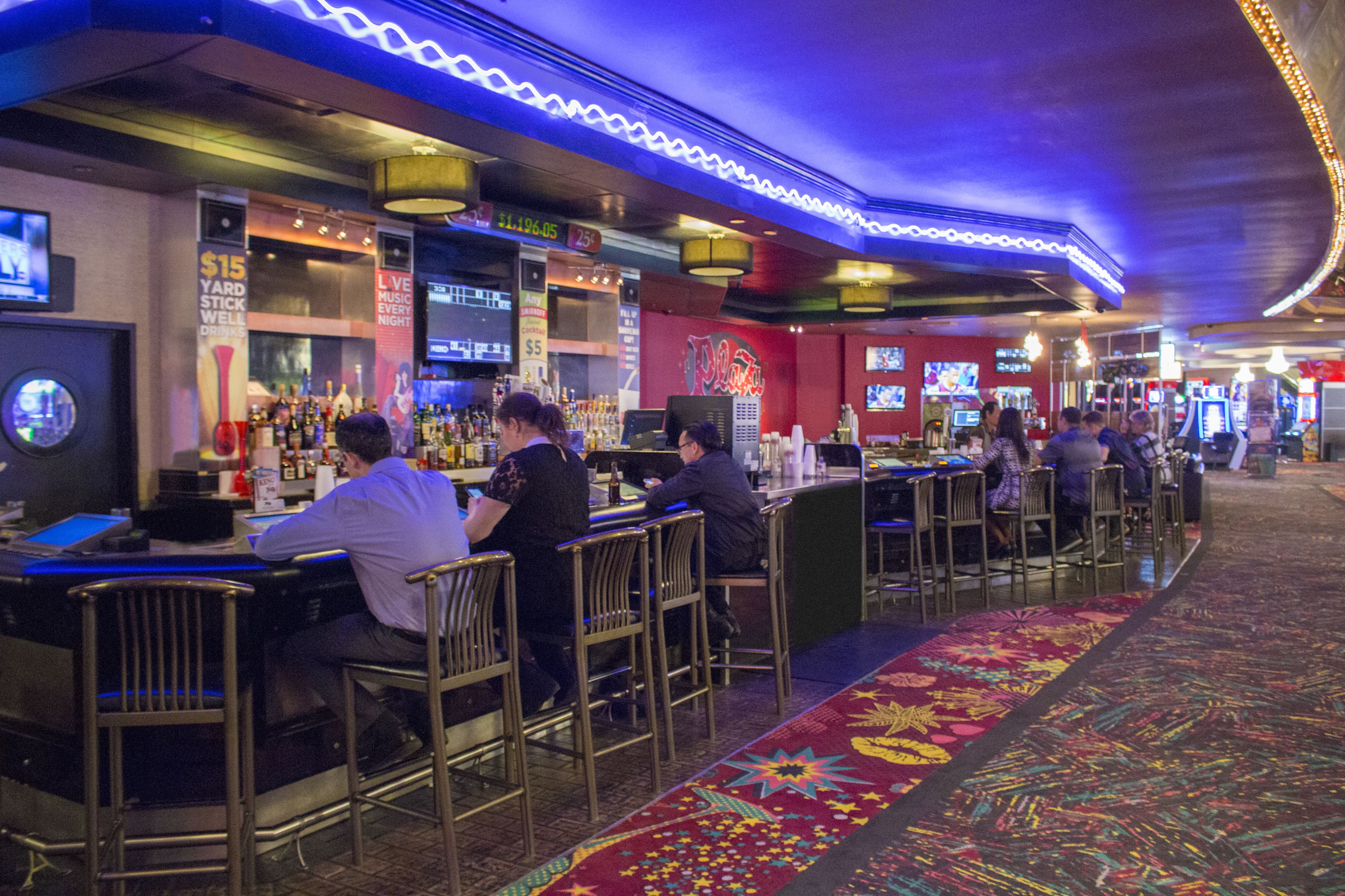 A bar area with multiple seating arrangements and a bar counter.