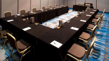 A conference room with a long table, chairs, and nameplates.