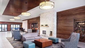 A spacious lobby with a fireplace, seating area, and a 'Sanctuary' sign.