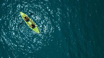 A person kayaking on a body of water.