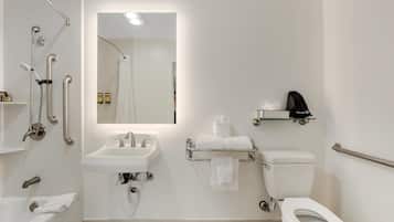 Un baño moderno con bañera, lavabo, inodoro y zona de ducha.